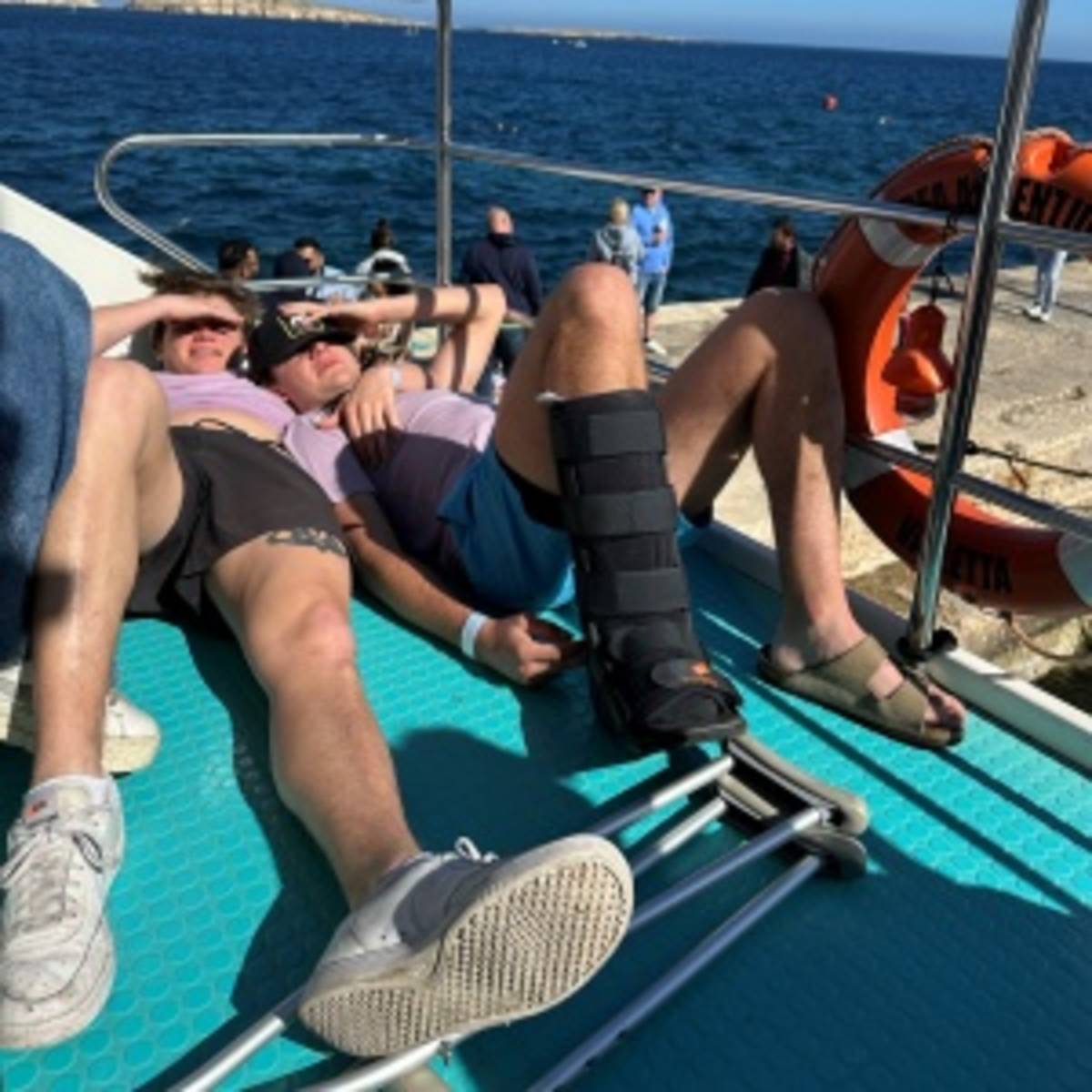 2 students relaxing on the boat