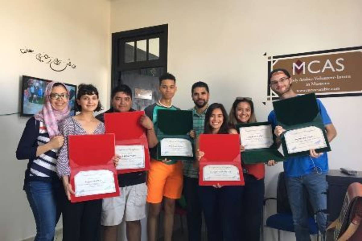 Participants holding their certificates.