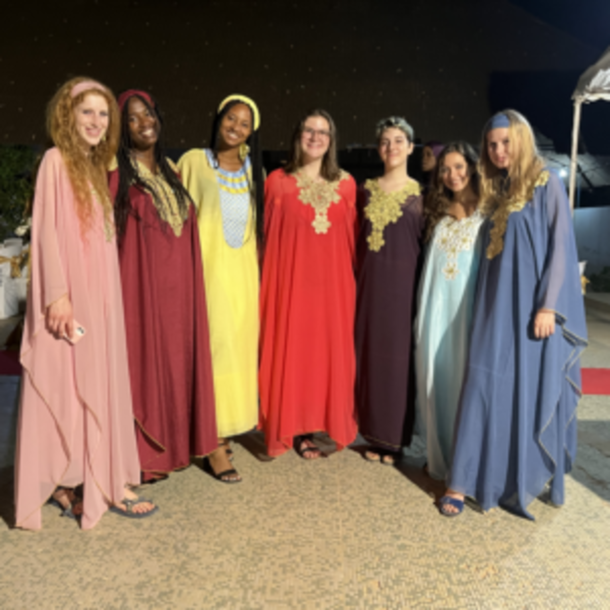 7 students in traditional dress attend wedding in Senegal