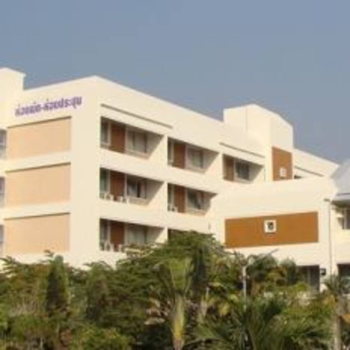 A beachfront hotel with a spacious white building.