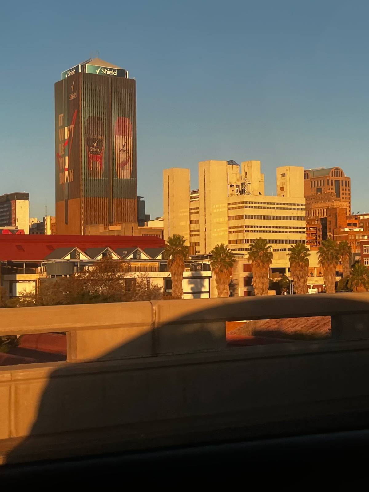 A city skyline glows gold in the South African sunset
