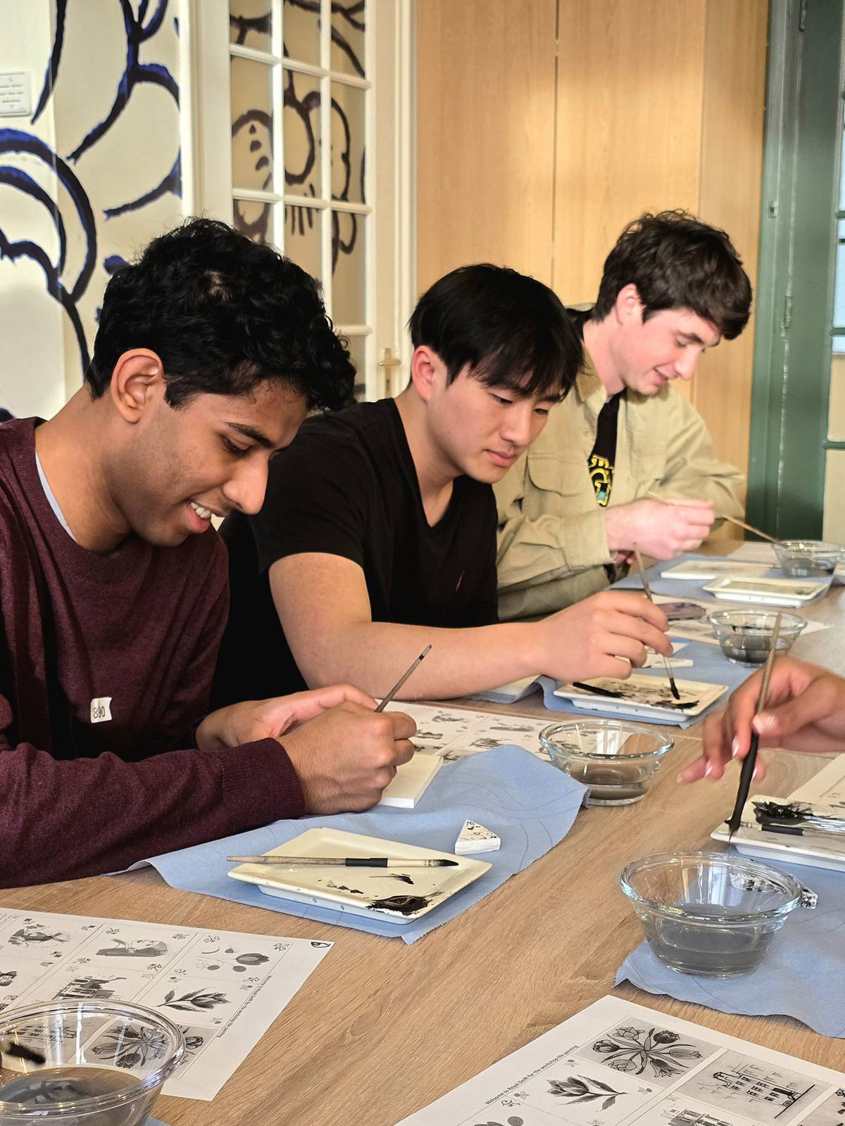 A few of our spring students painting a Delft Blue tile in Delft 