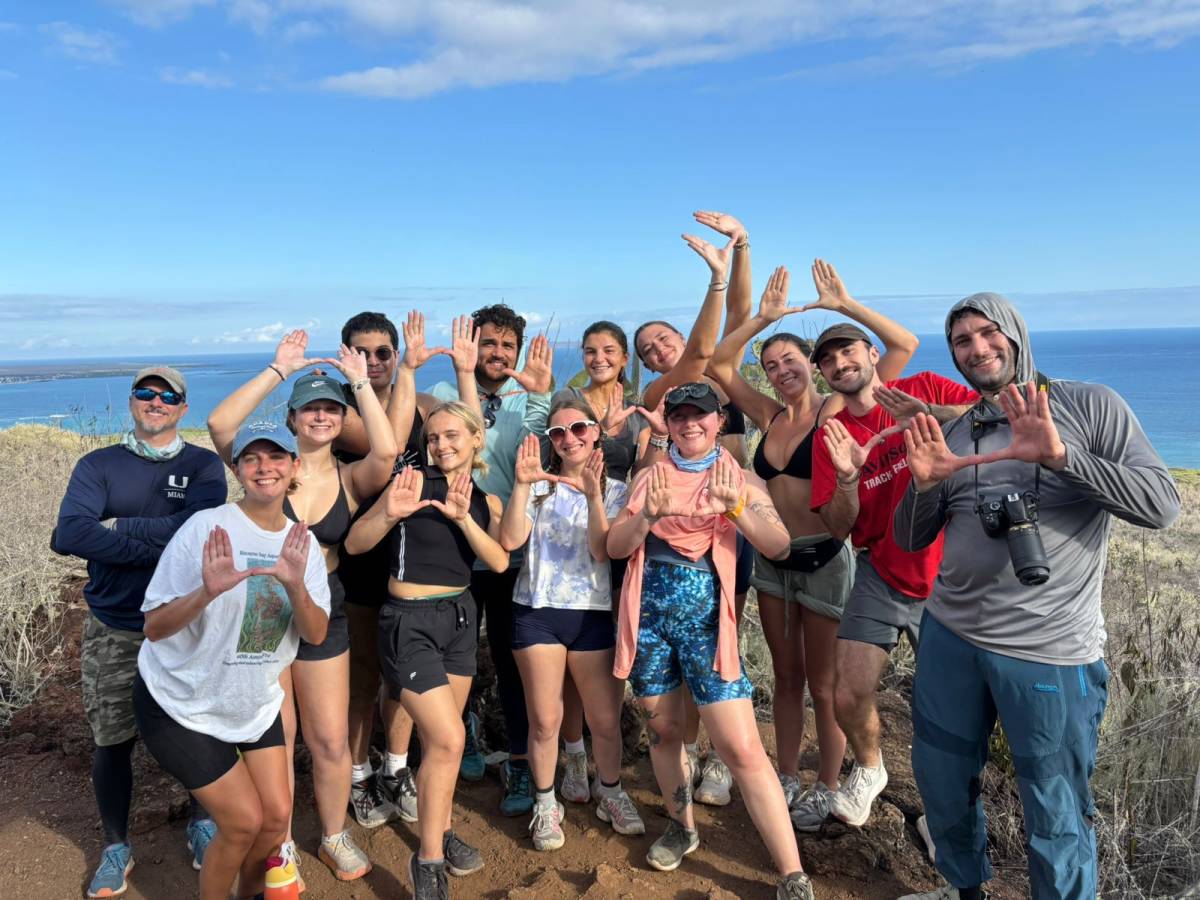a group of people posing for a photo with their palms open