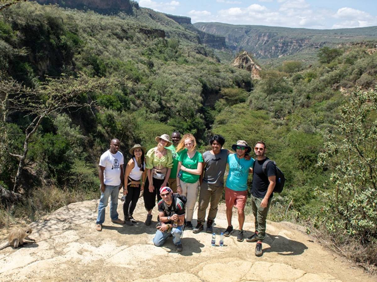 A group of people posing outdoors on a scenic overlook.