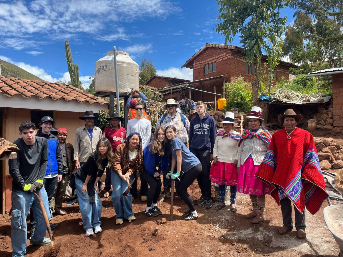 A group of students doing community service work with local community members on a Peru Teen travel program.