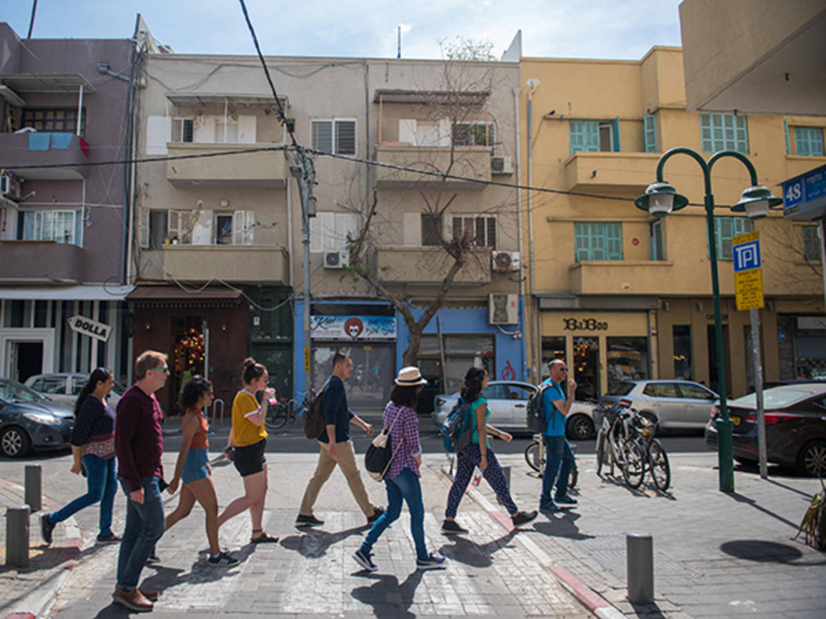 A group of students walking through a neighborhood