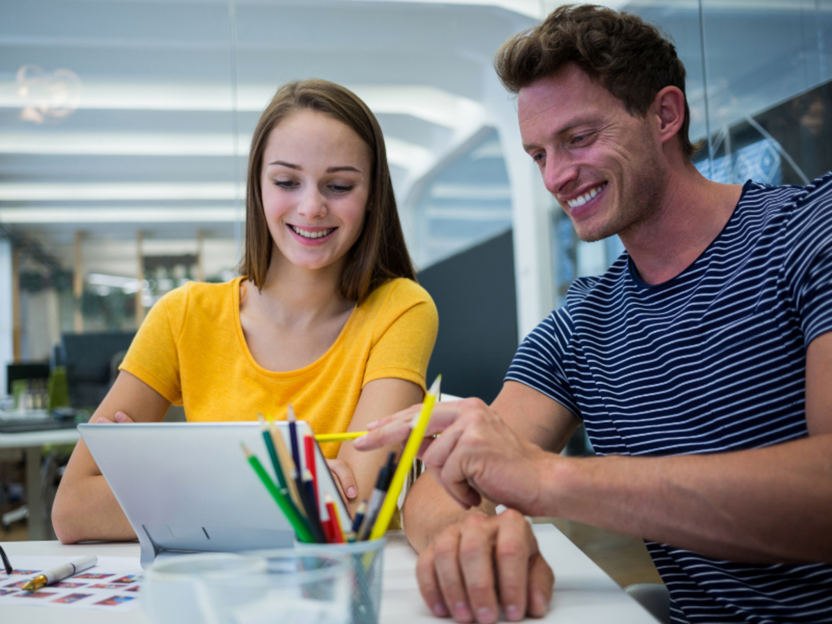 a man and woman collaborating in an office setting