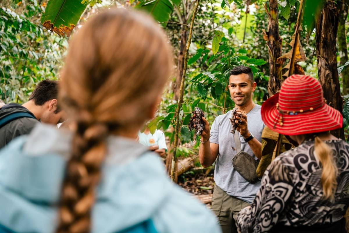 a man demonstrating for a group during an outdoor activity