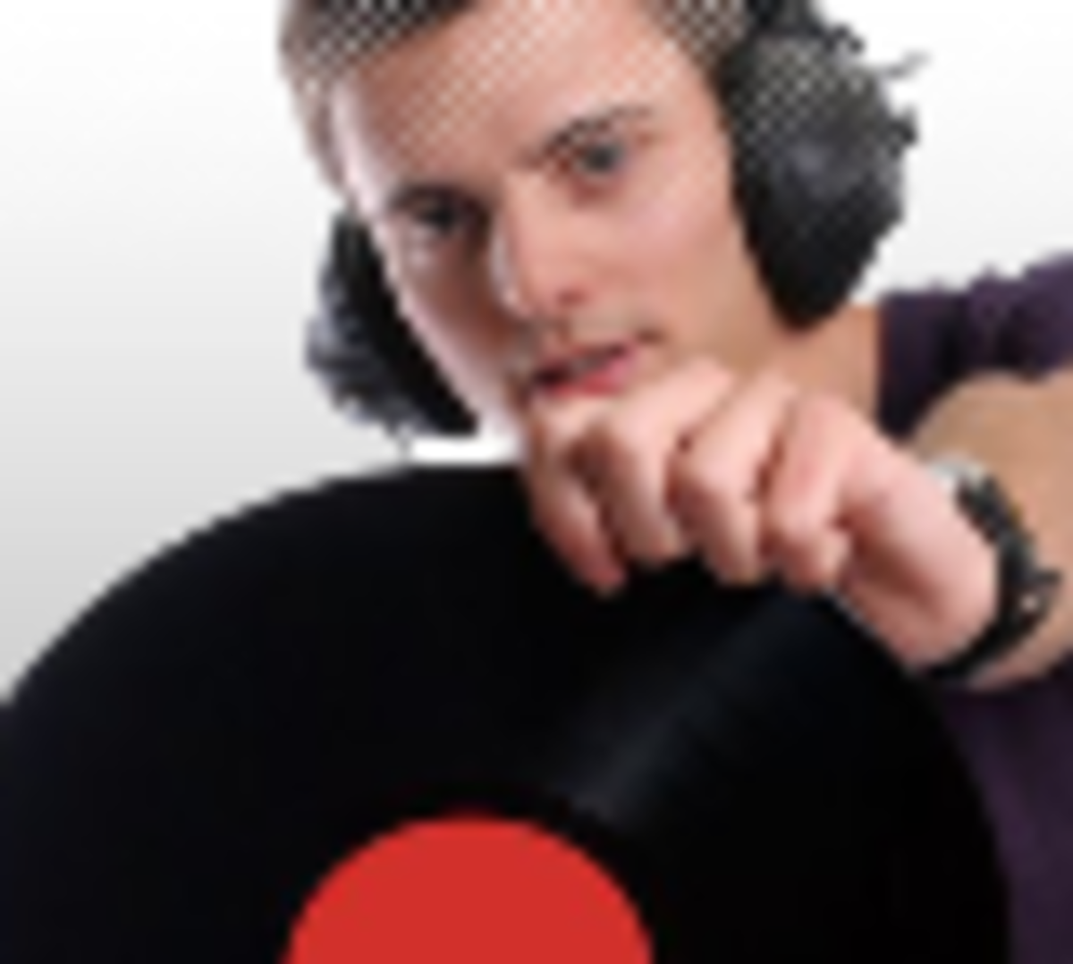 A man holding a vinyl record with headphones on, enjoying music.