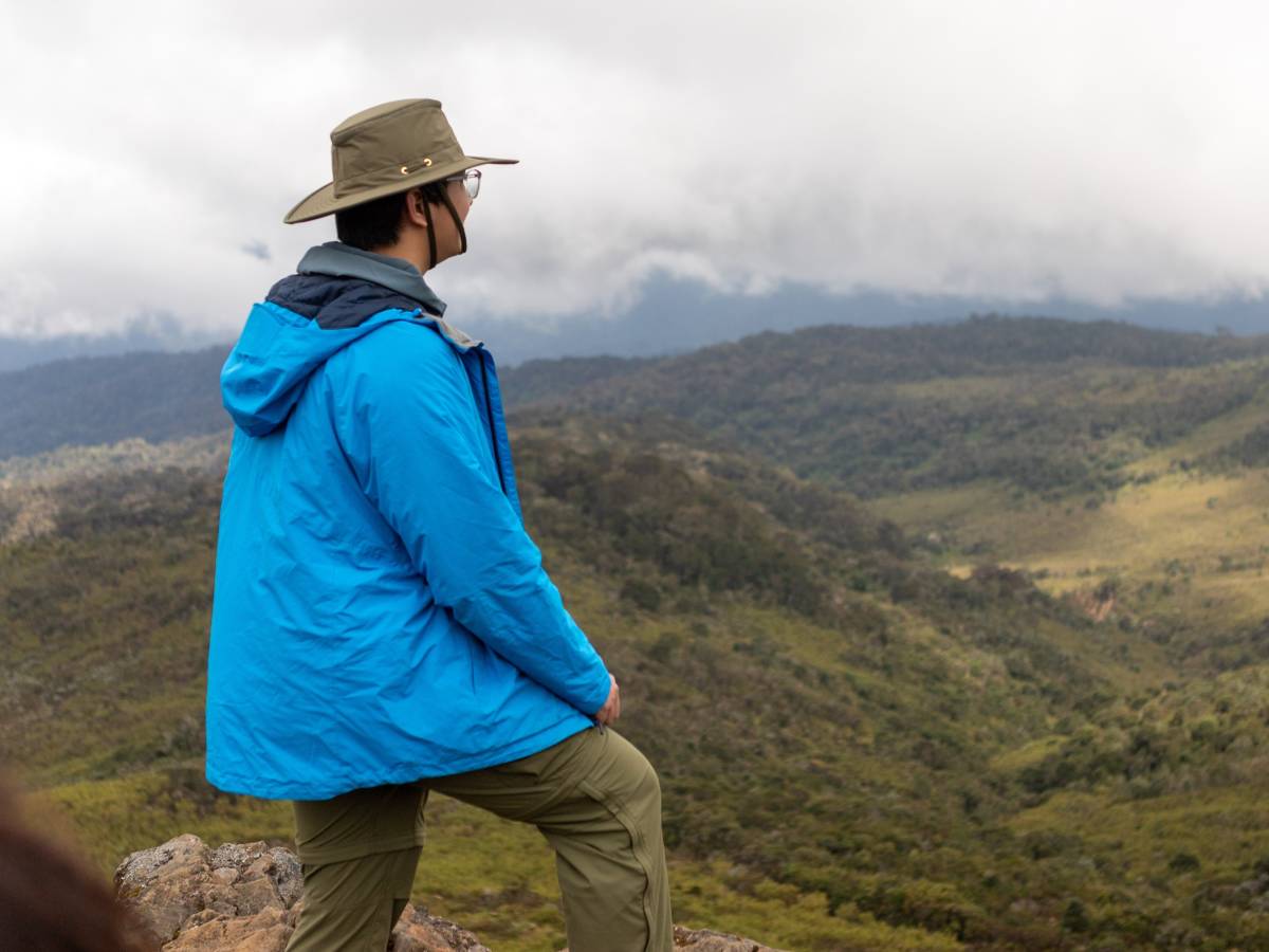 A man standing overlooking a view from mountain