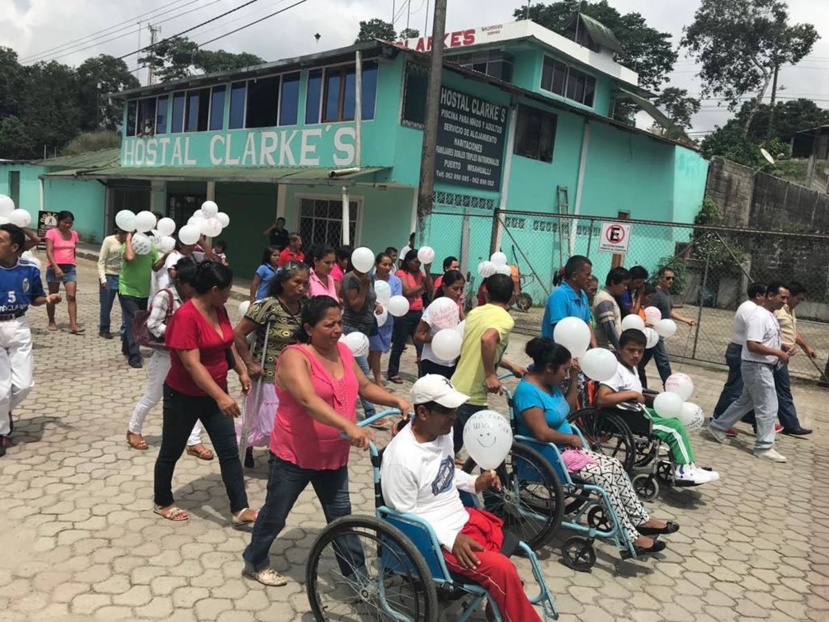A parade with several wheelchairs.