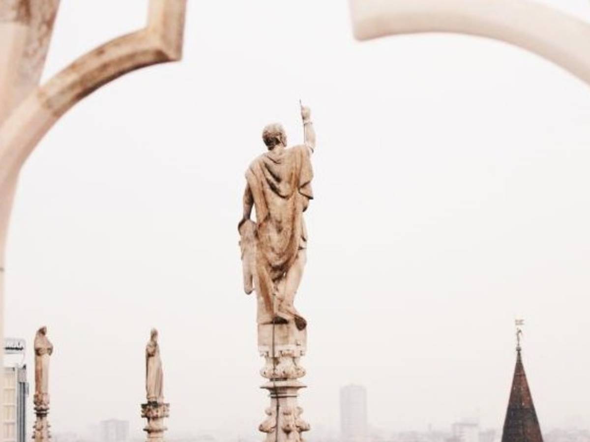 a statue atop Duomo di Milano