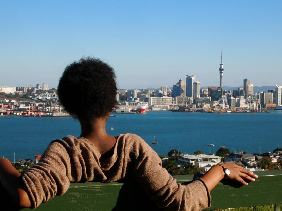 a student looking at downtown Auckland from across the bay