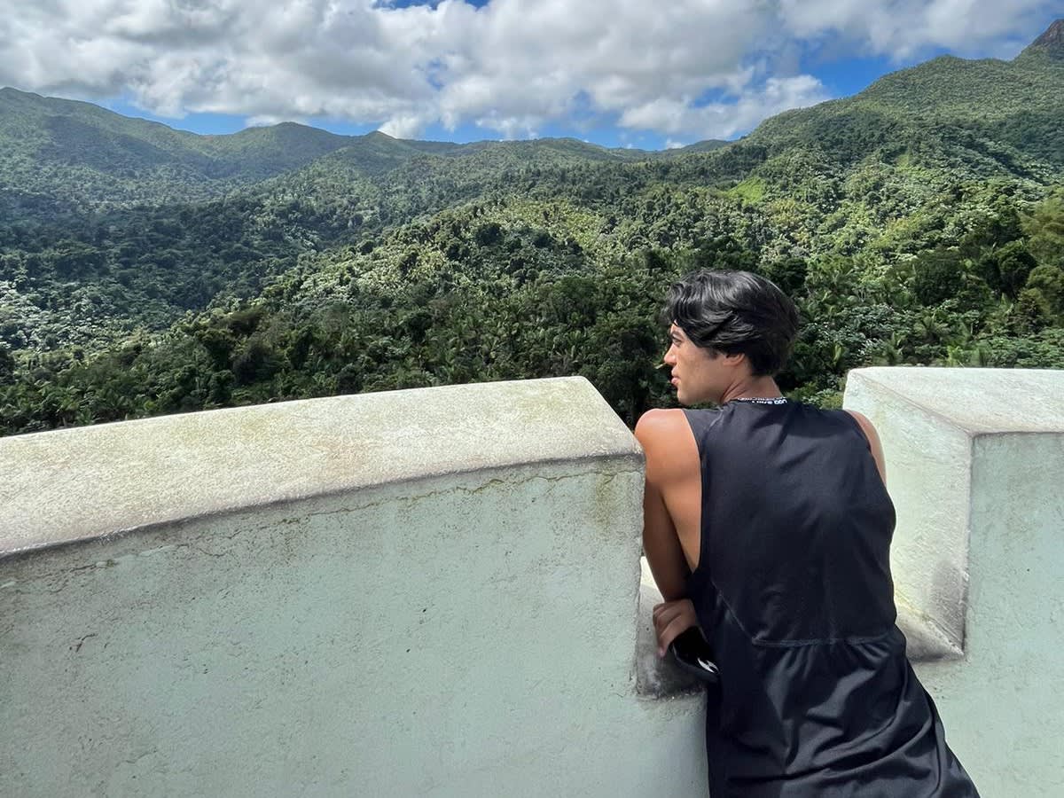 A student looks out over the jungle