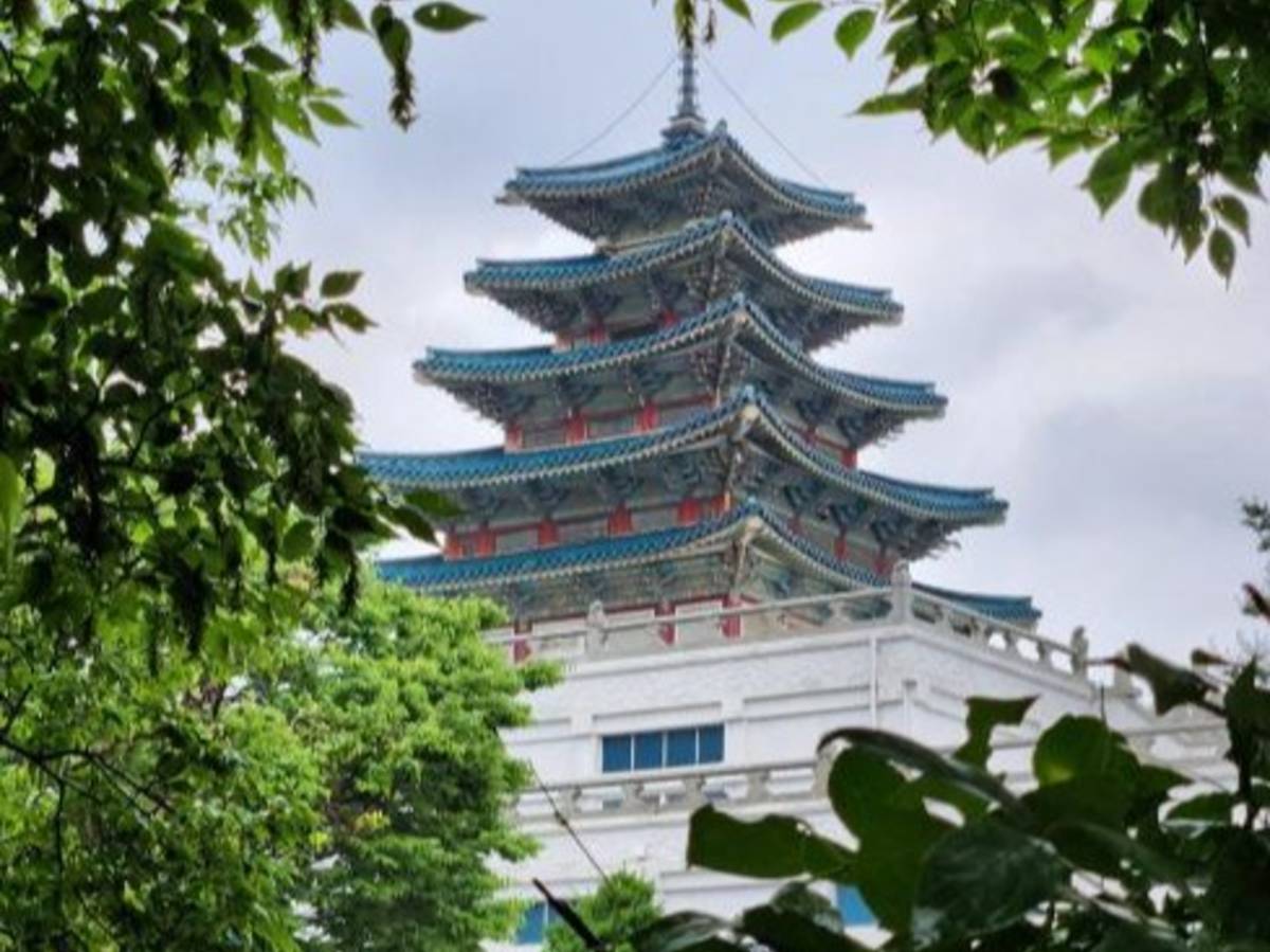 A view of a Korean pagoda temple through tree.