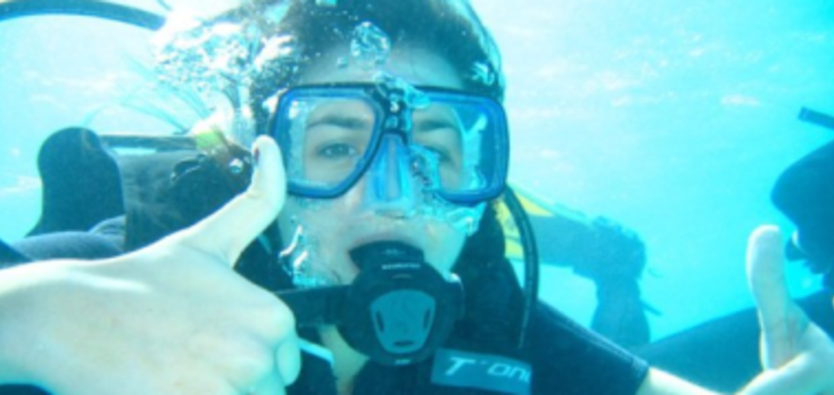 A woman in a scuba suit underwater