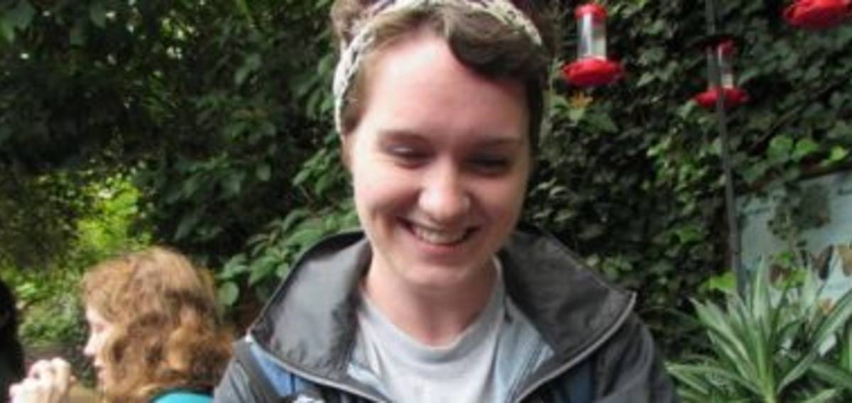 A woman smiling and a woman in at the back