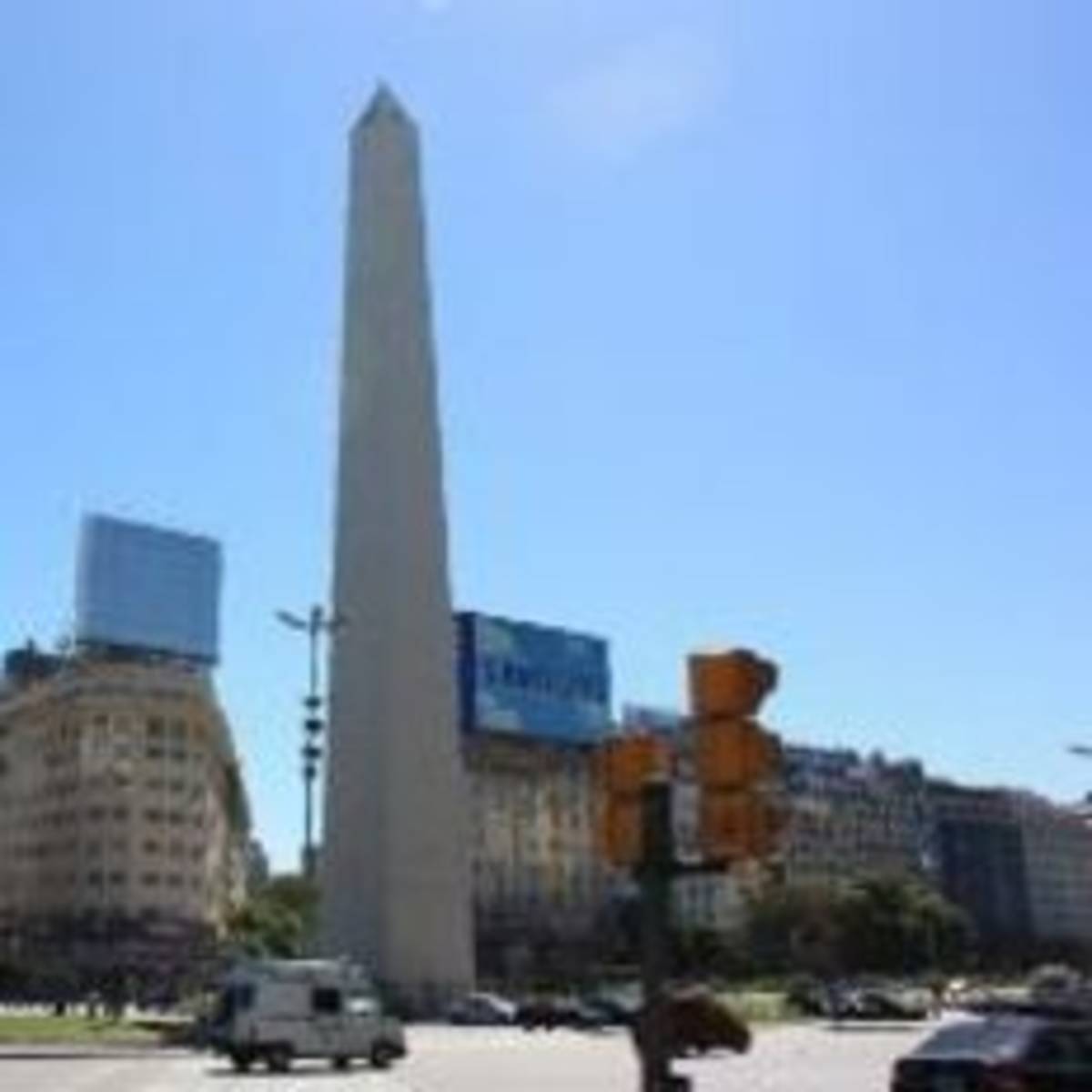 An obelisk standing tall amidst a bustling city street