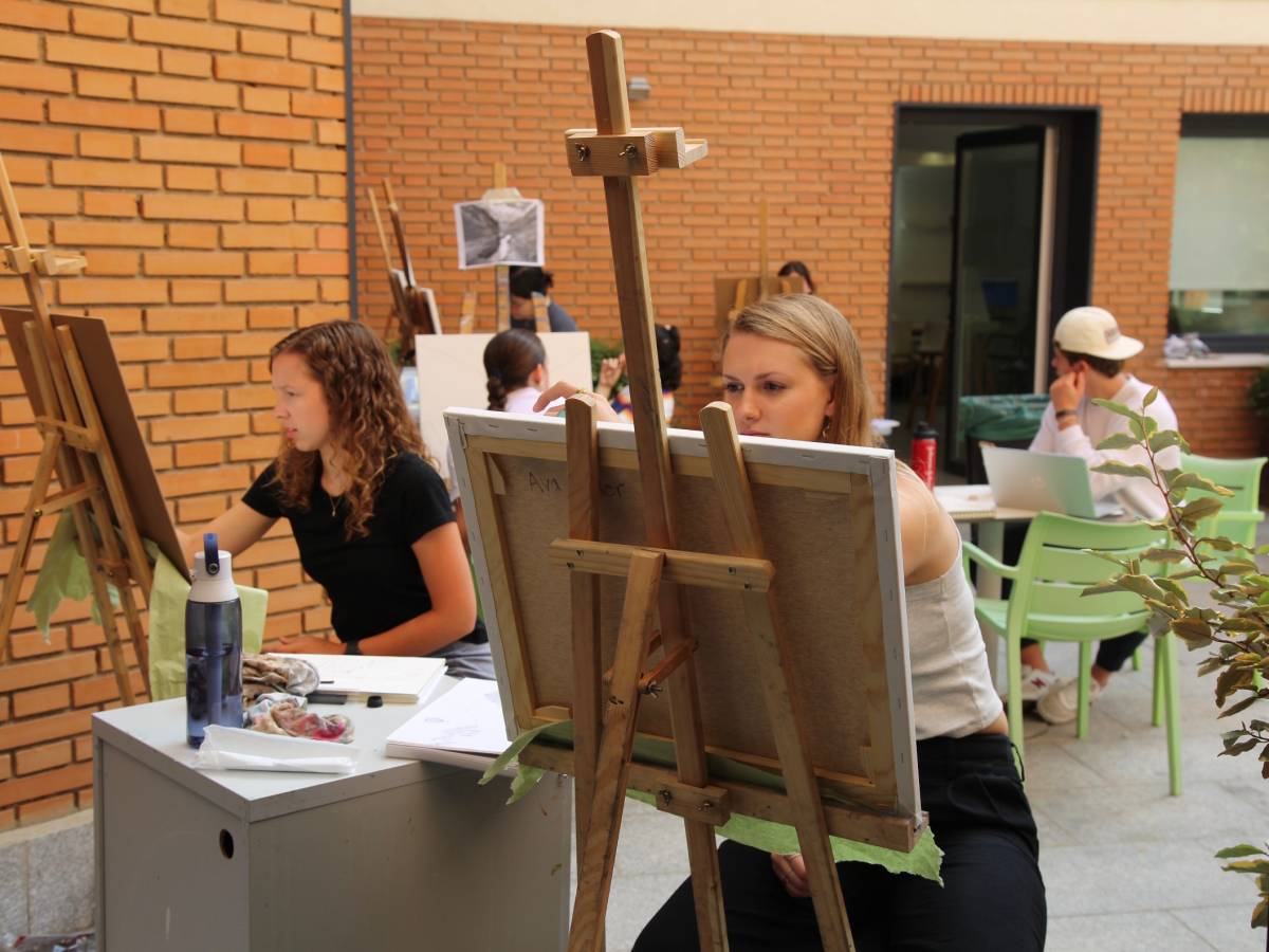 Art students paint outside.