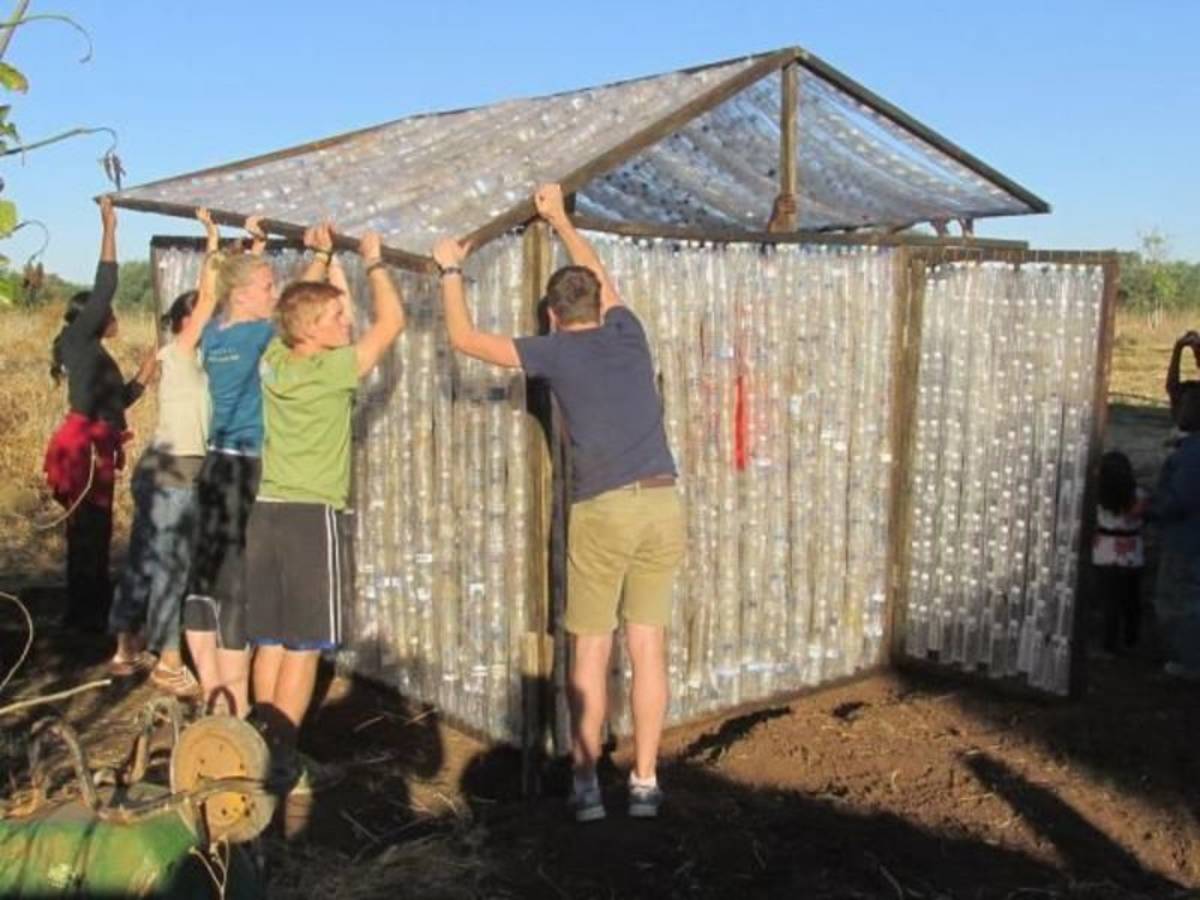 building volunteers holding a roof together
