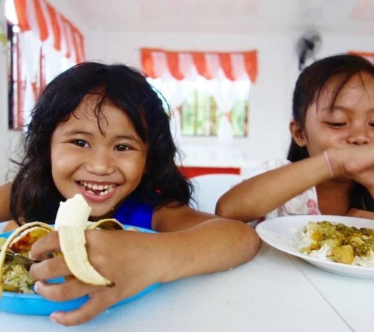 two happy kids at a community center in the Philippines