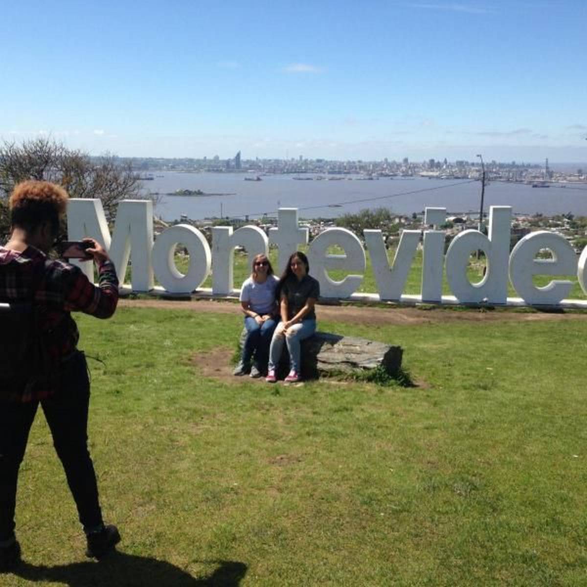 Students take a photo on the Montevideo sign during a study abroad in Uruguay.