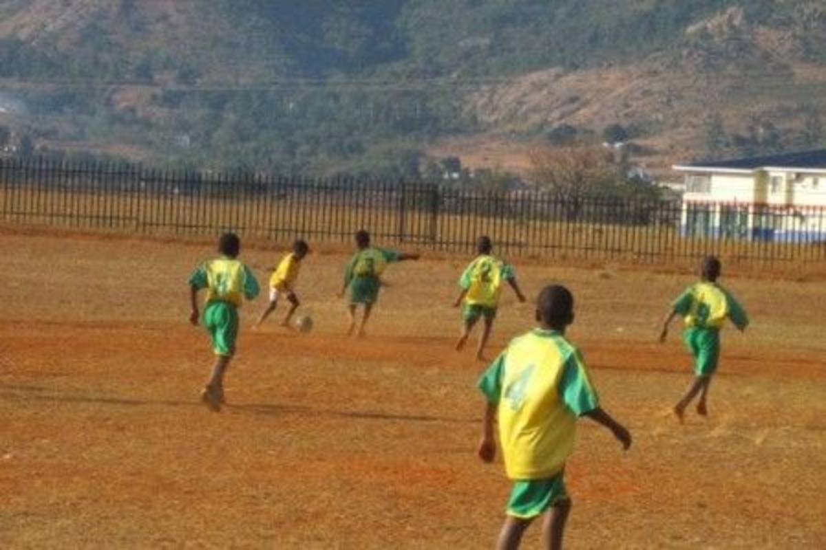 children playing football at the field