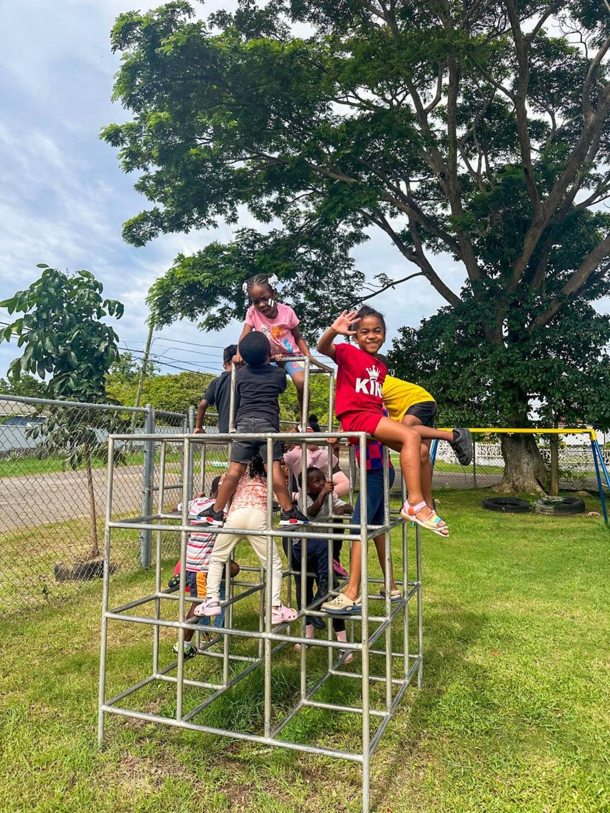Children Playing on a Metal Structure in Jamaica