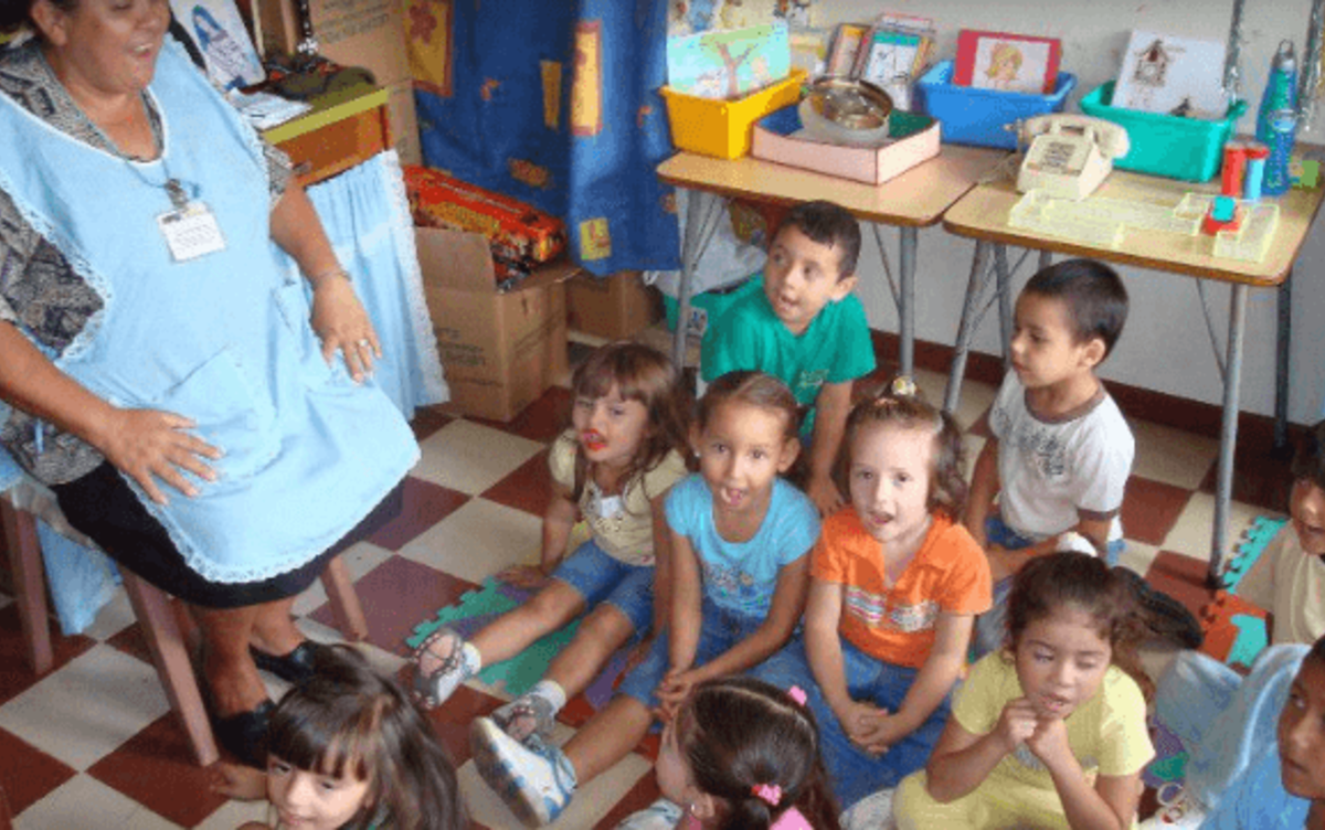 children singing with volunteer teacher