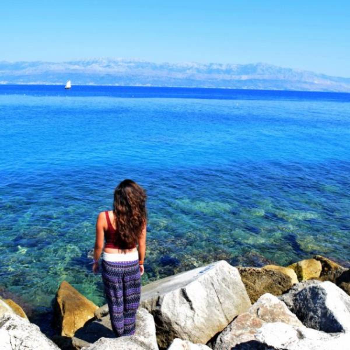 student looking out over the seaside 