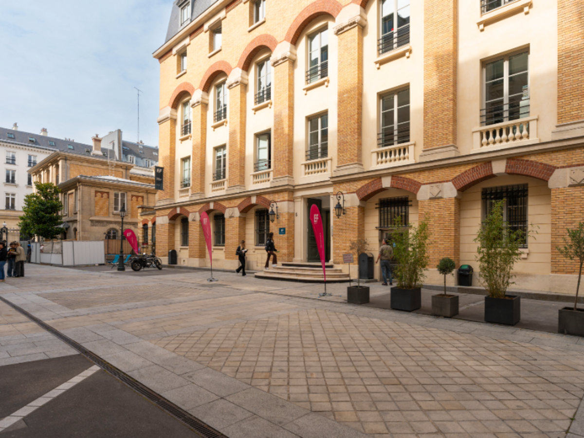 Exterior view of the EF Paris school building with red banners and students near the entrance.