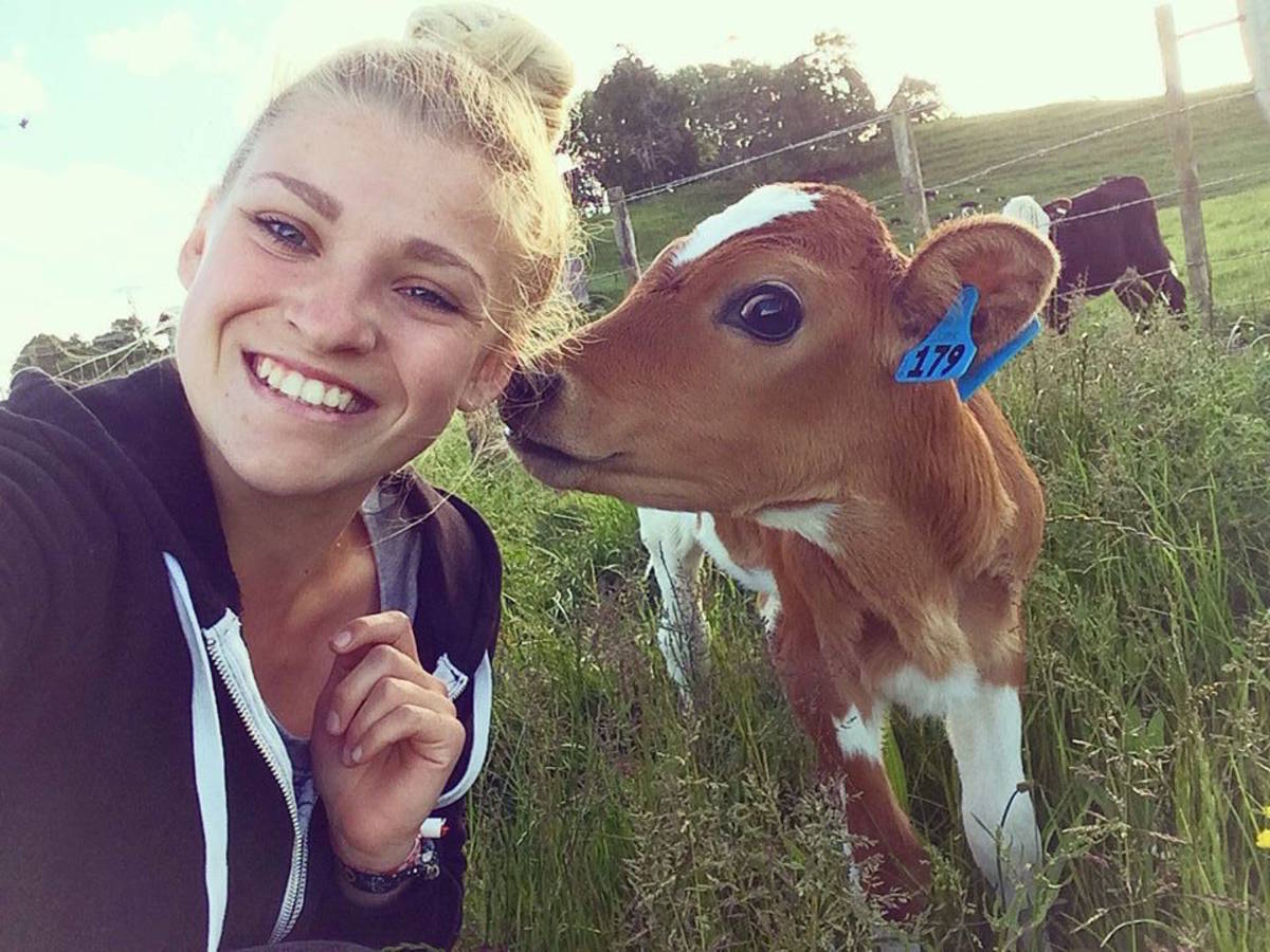 Farmstay Girl looking after the calf in New Zealand