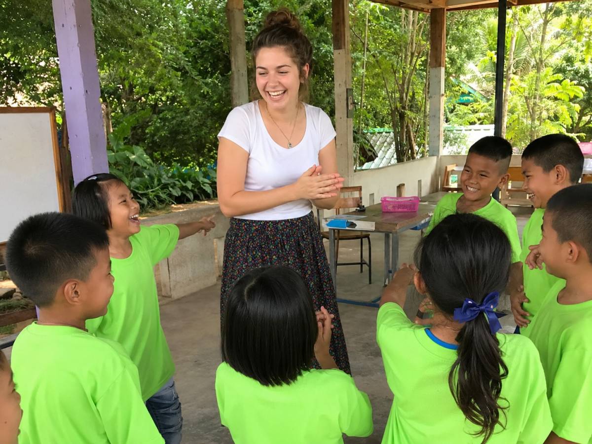 Female teacher playing an English game with Thai children