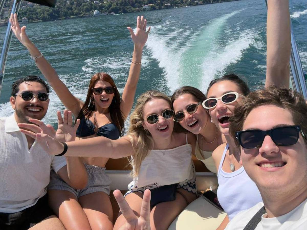 Five students posing on a boat in Lake Como.