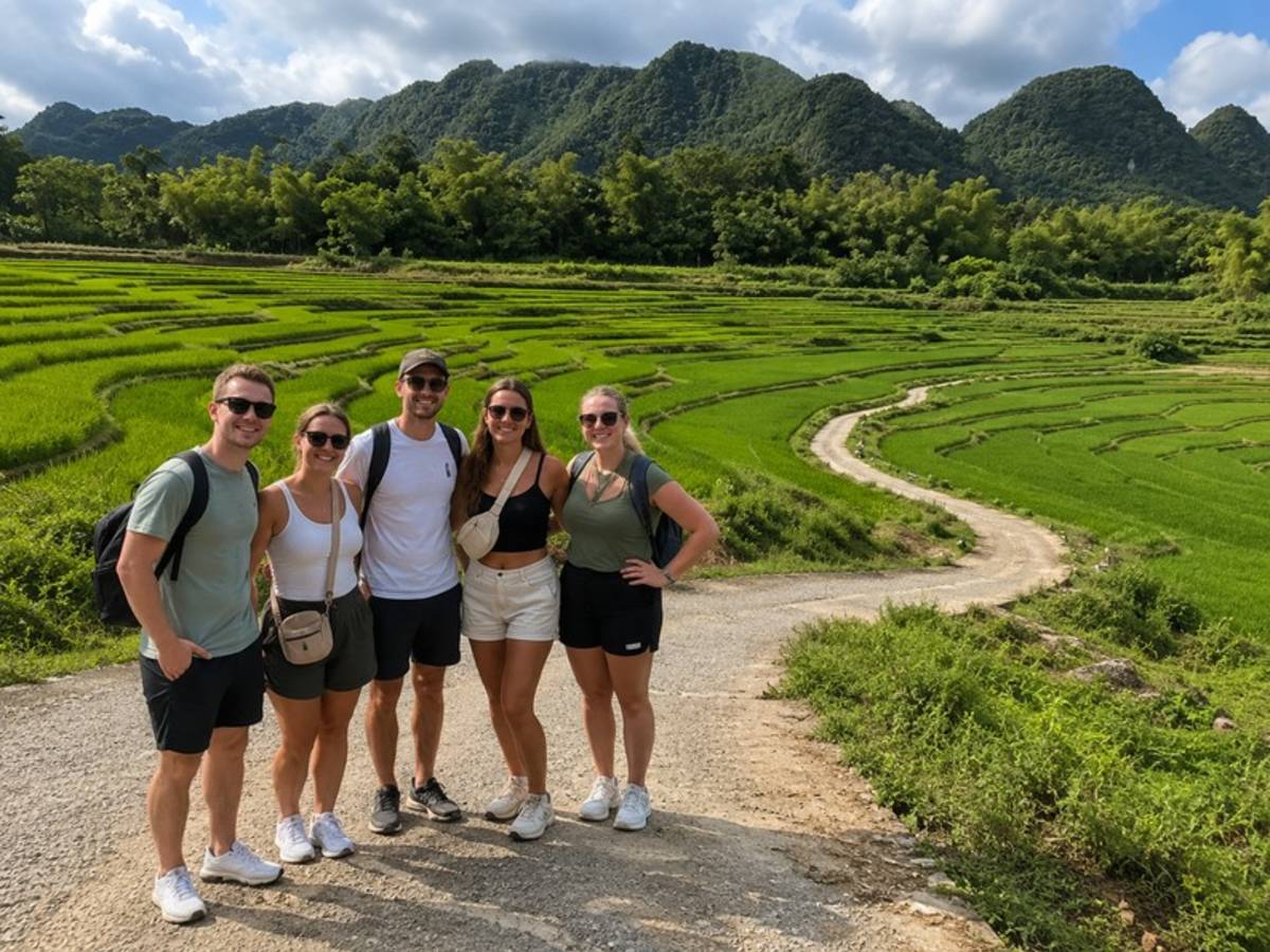 Five travellers standing beside green rice terraces in Vietnam