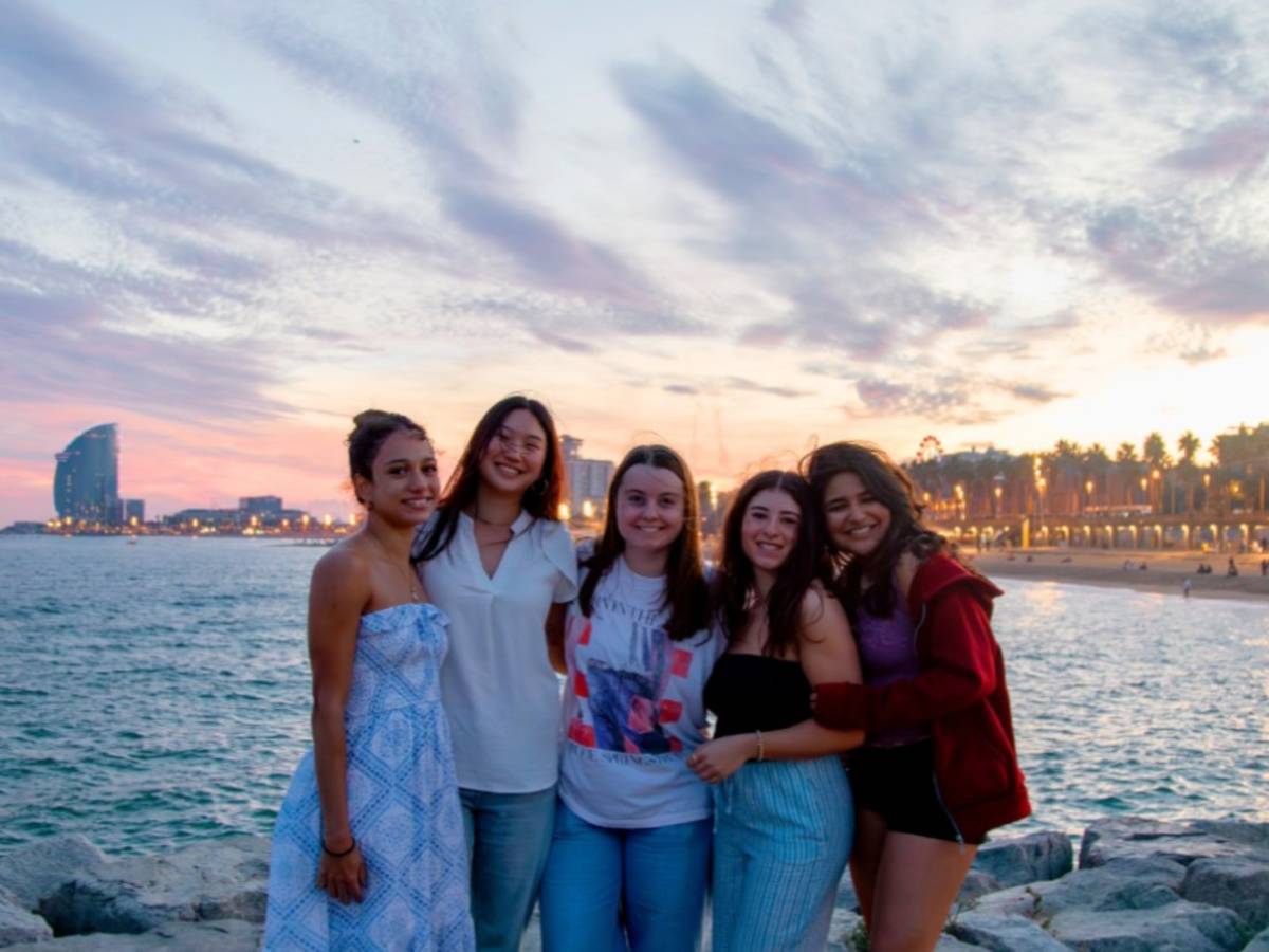 Friends on the Barceloneta beach in Barcelona, Spain.
