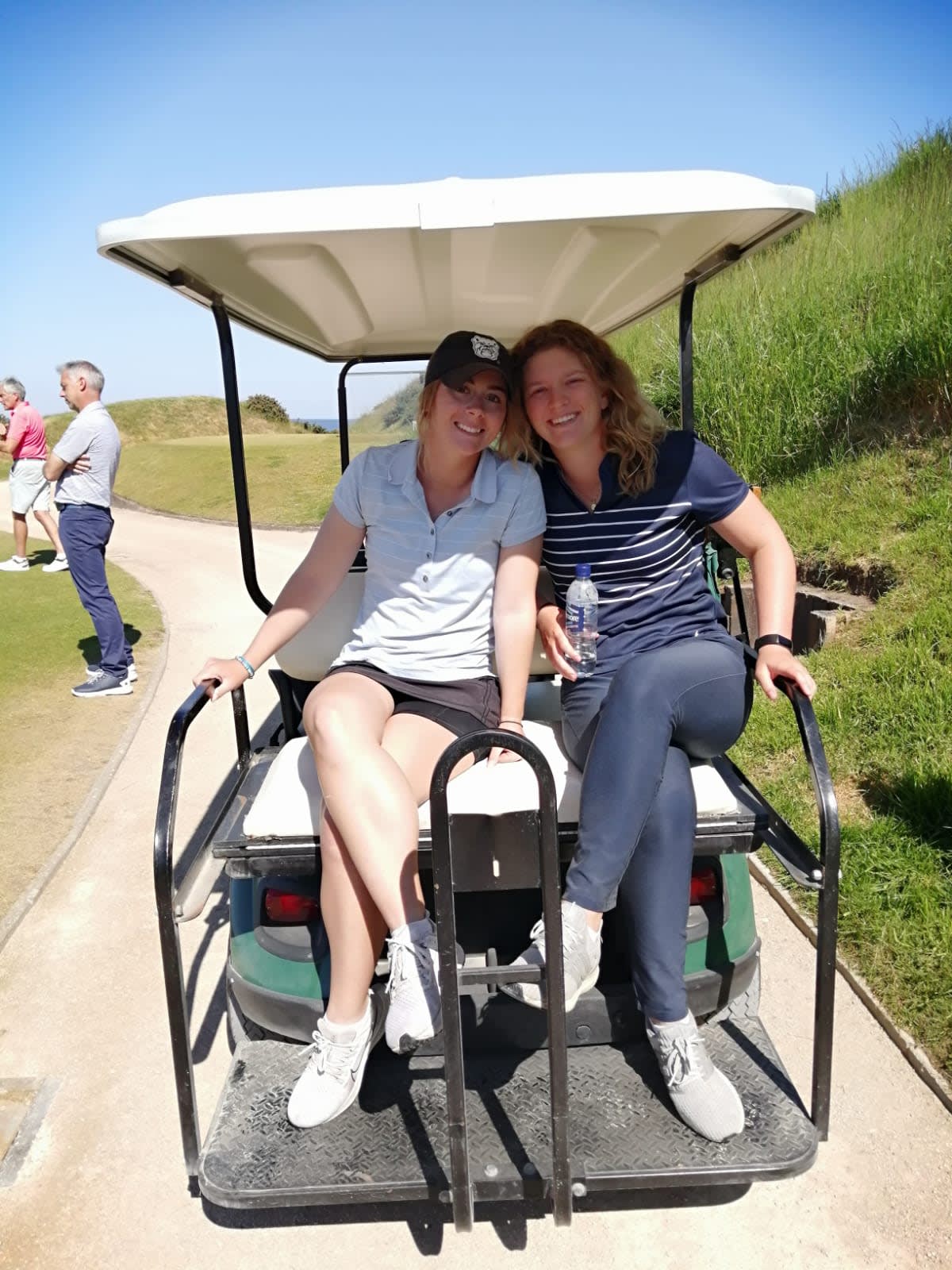 Golf students on a golf cart