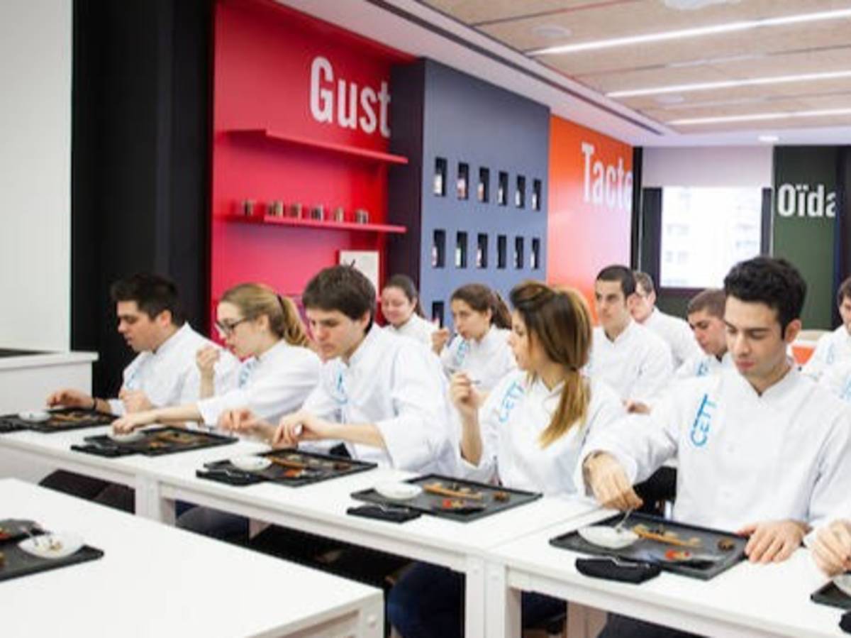 Group of cooking students preparing a dish