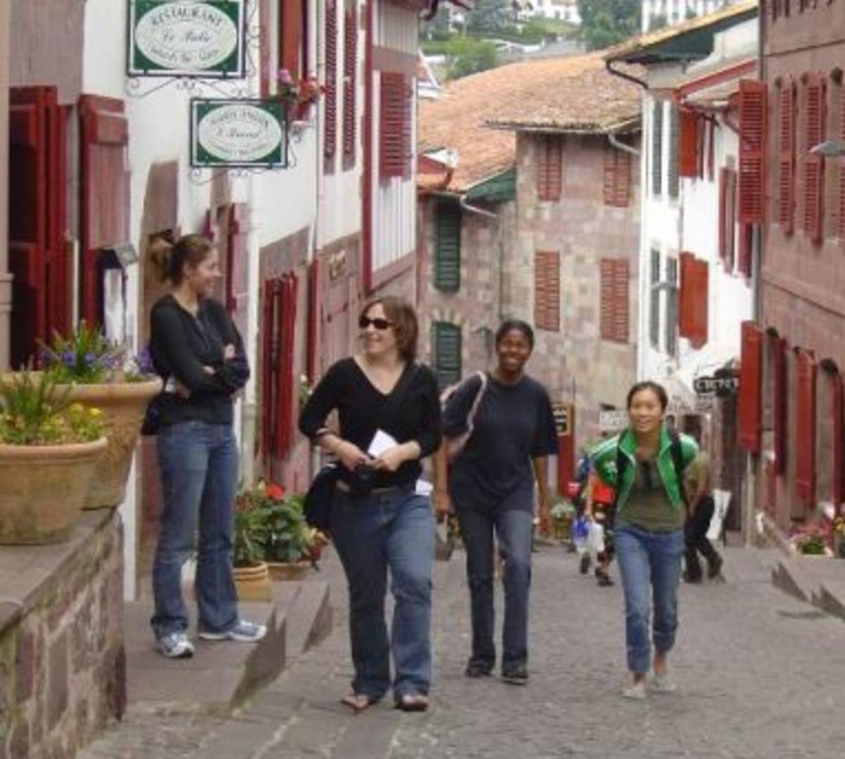 Group of people strolling down historic cobblestone street