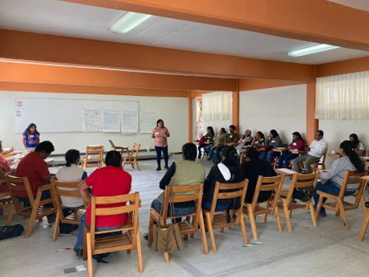 Group of psychology and social work interns collaborating and discussing community outreach in Oaxaca, Mexico, during an internship program.