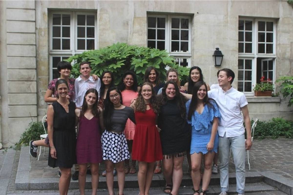 group of putney students in france posing in front of a building