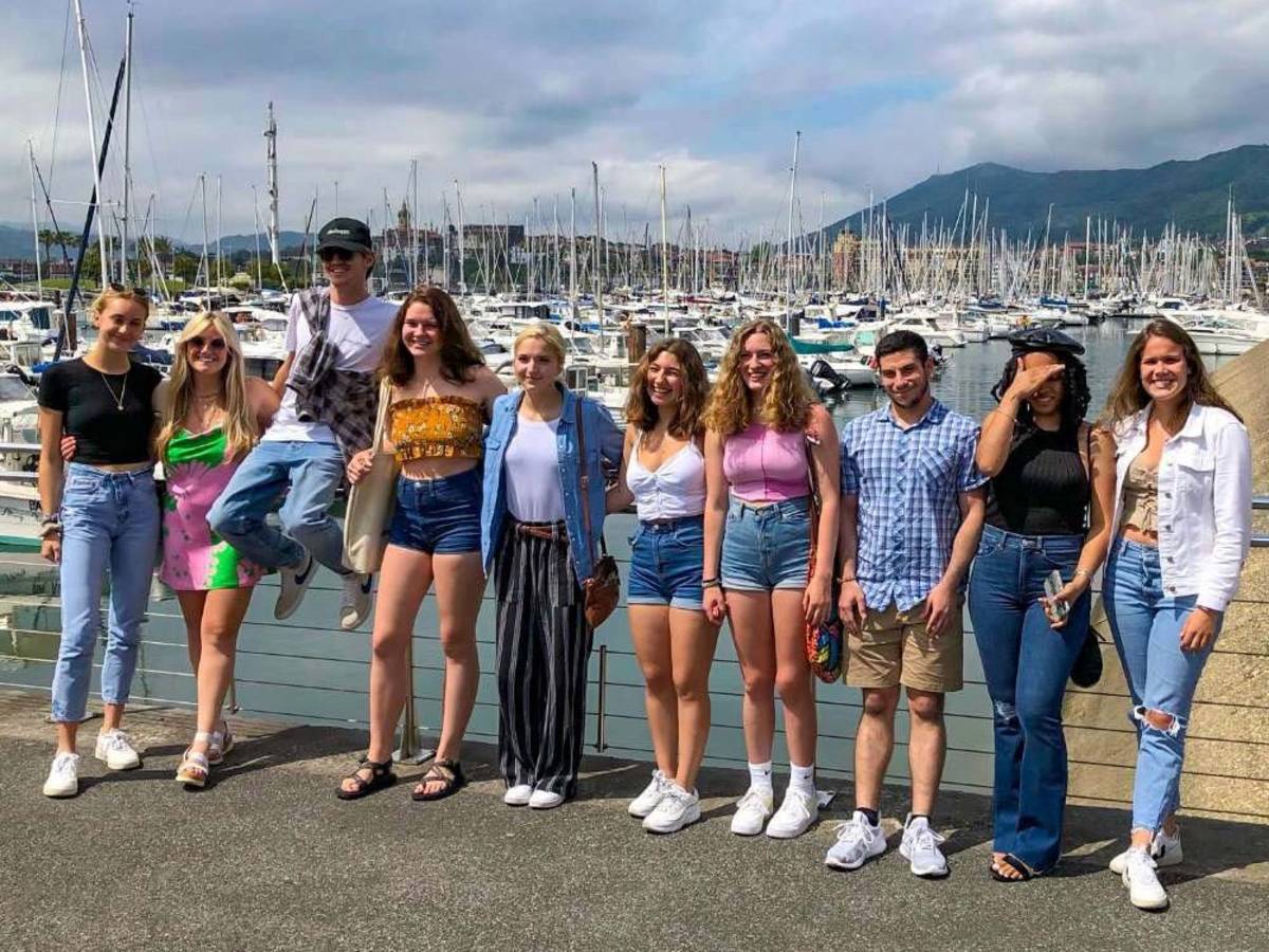 Group of students standing in front the port in Spain