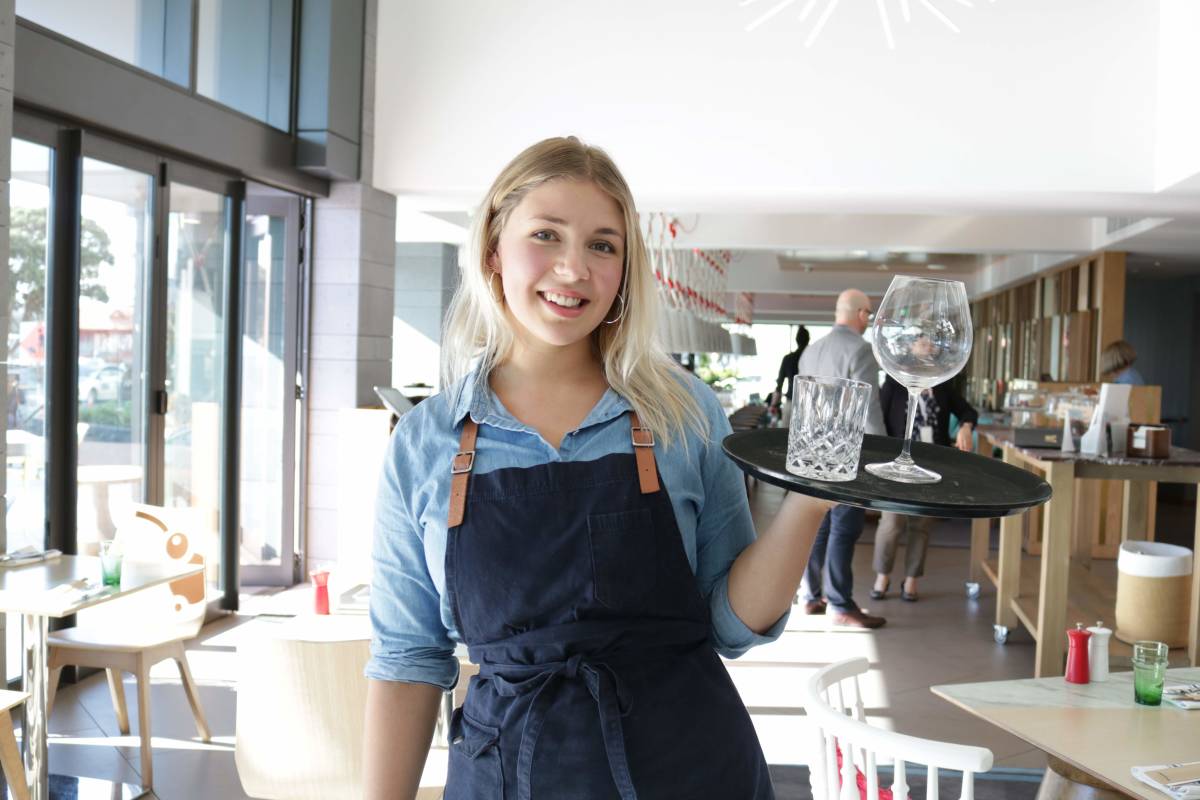 Hannah working as a waitress in Auckland