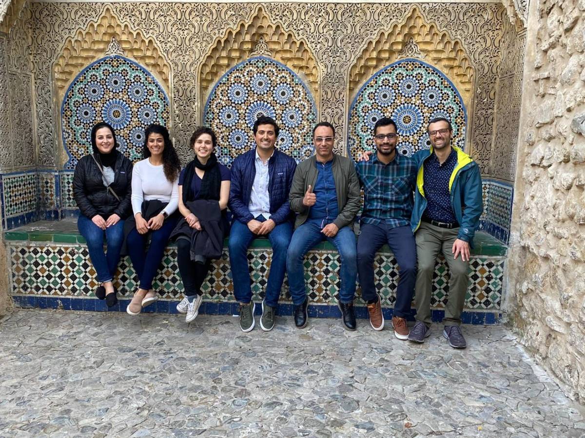 IAHQ Interns sitting on a bench taking a group photo