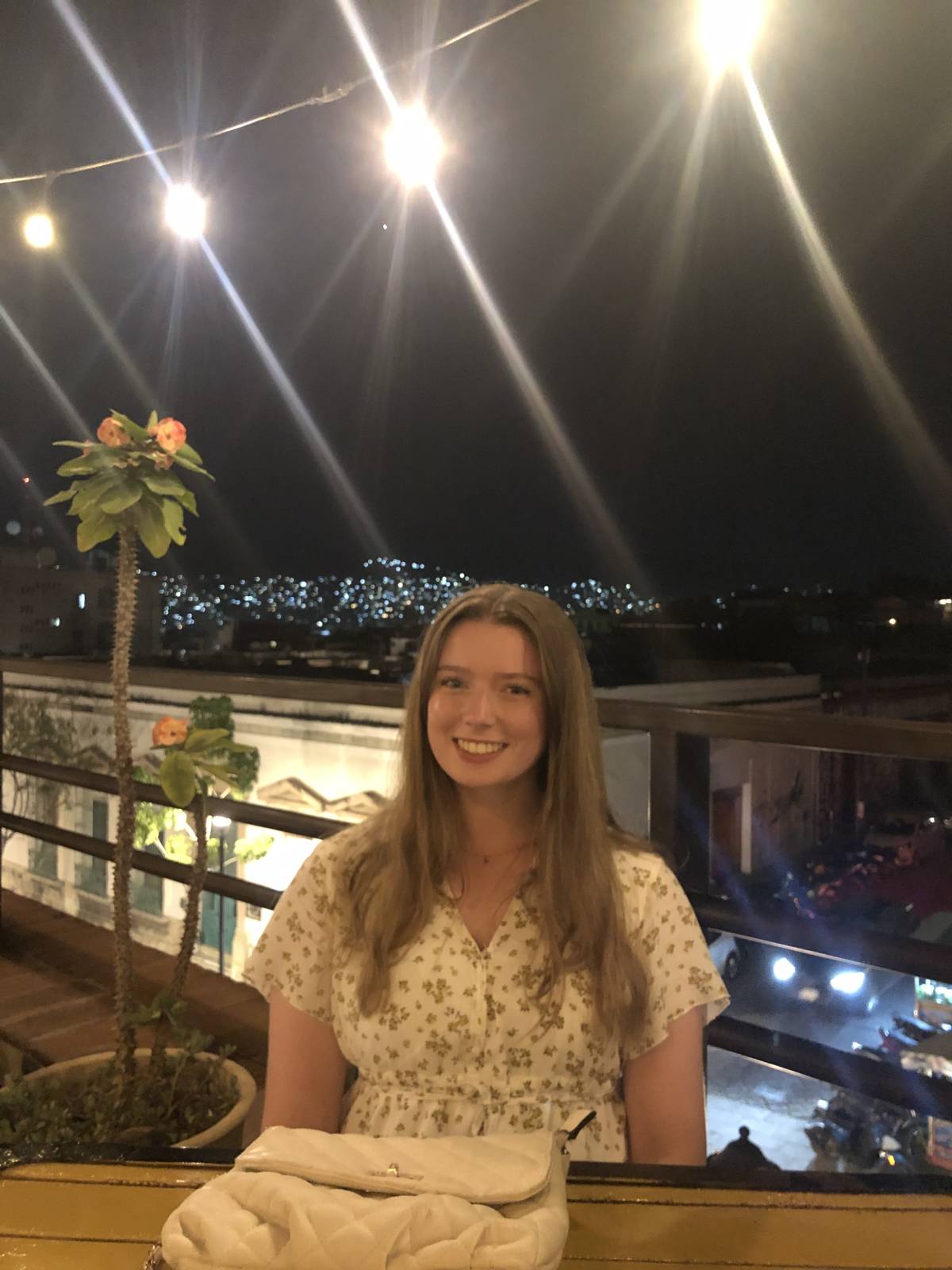 Intern enjoying nightlife in Oaxaca, Mexico, socializing in a lively outdoor setting with local lights and music.