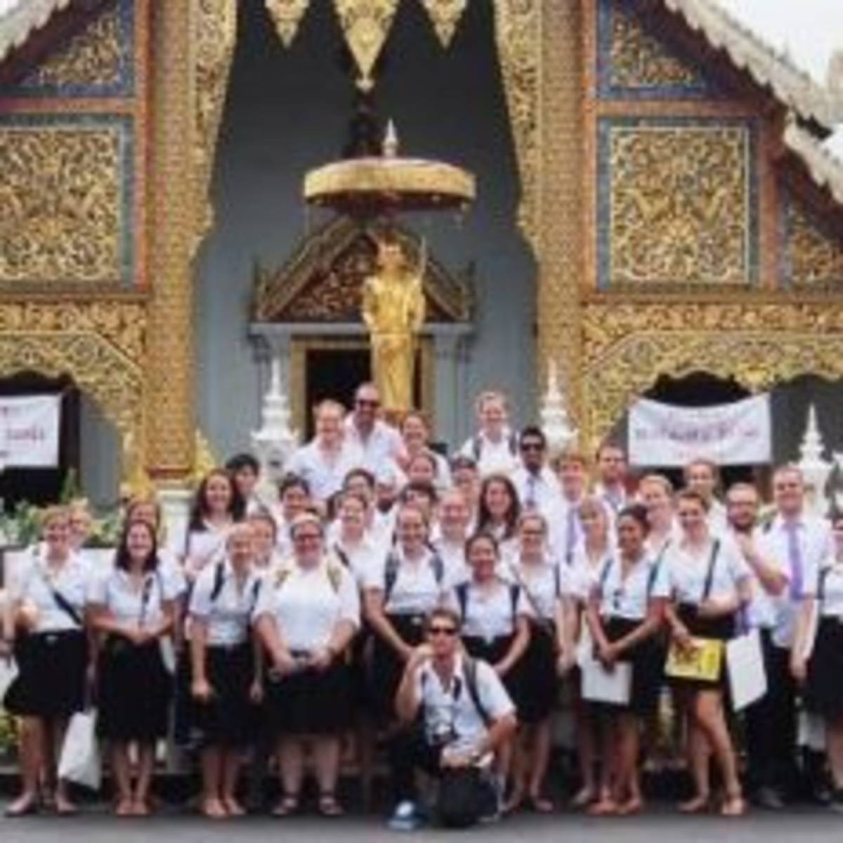 International students posing in front of a church