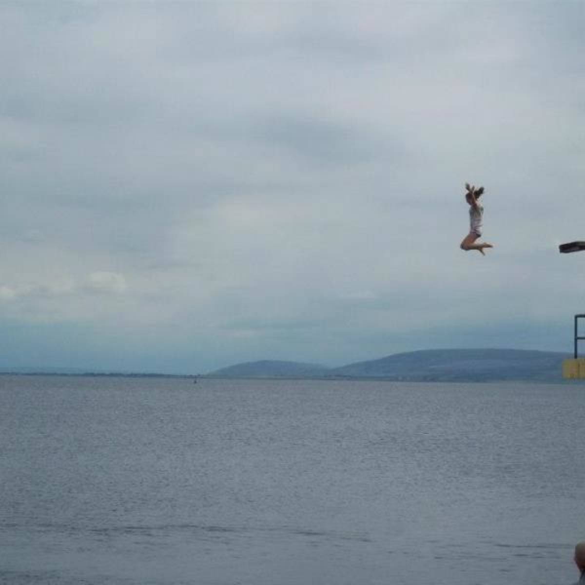 Student jumping into the bay