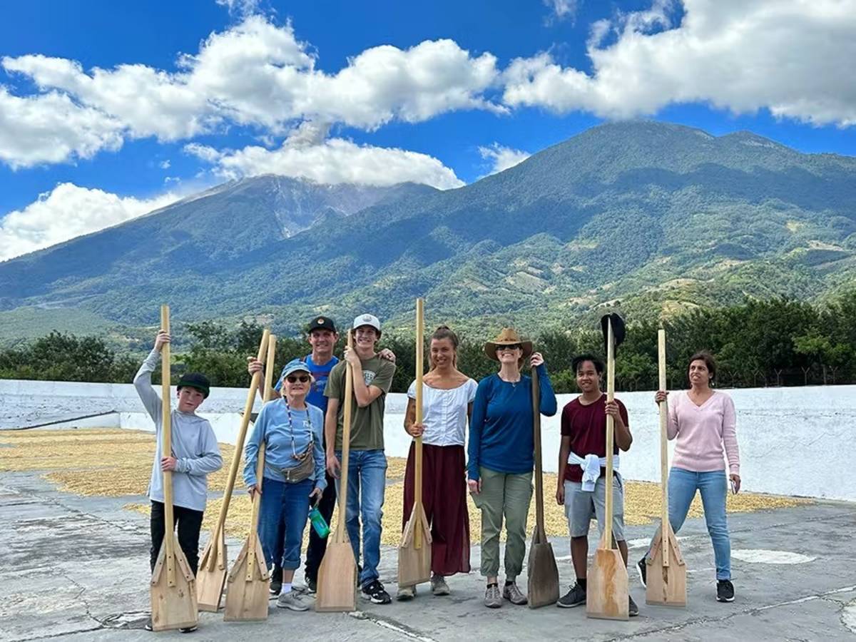 IVHQ Holiday experience volunteers sweeping up waste in Guatemala