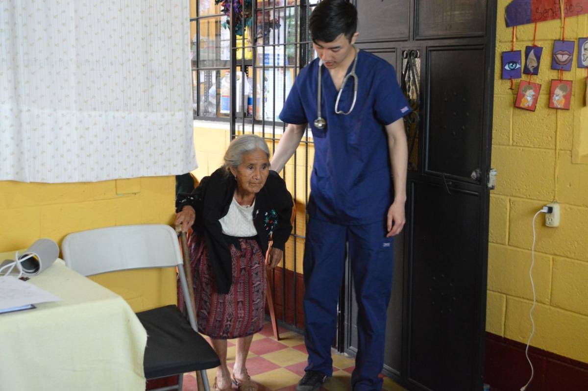 IVHQ Male Volunteer Assisting a Senior Citizen with a Checkup