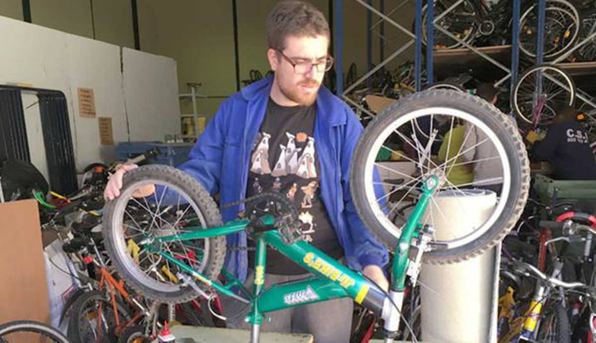 Volunteer fixing a bicycle